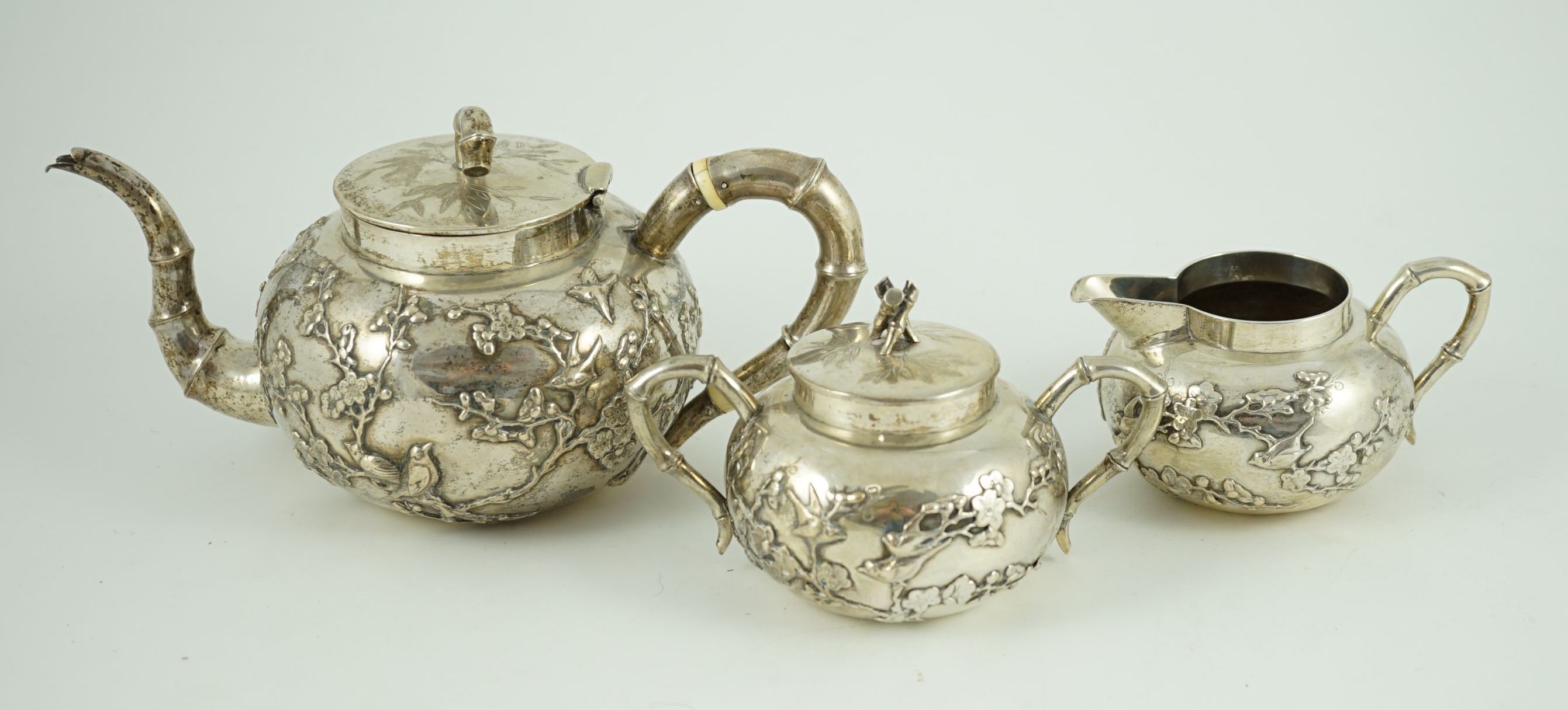 A 19th century Chinese Export silver three piece tea set by Cumshing?